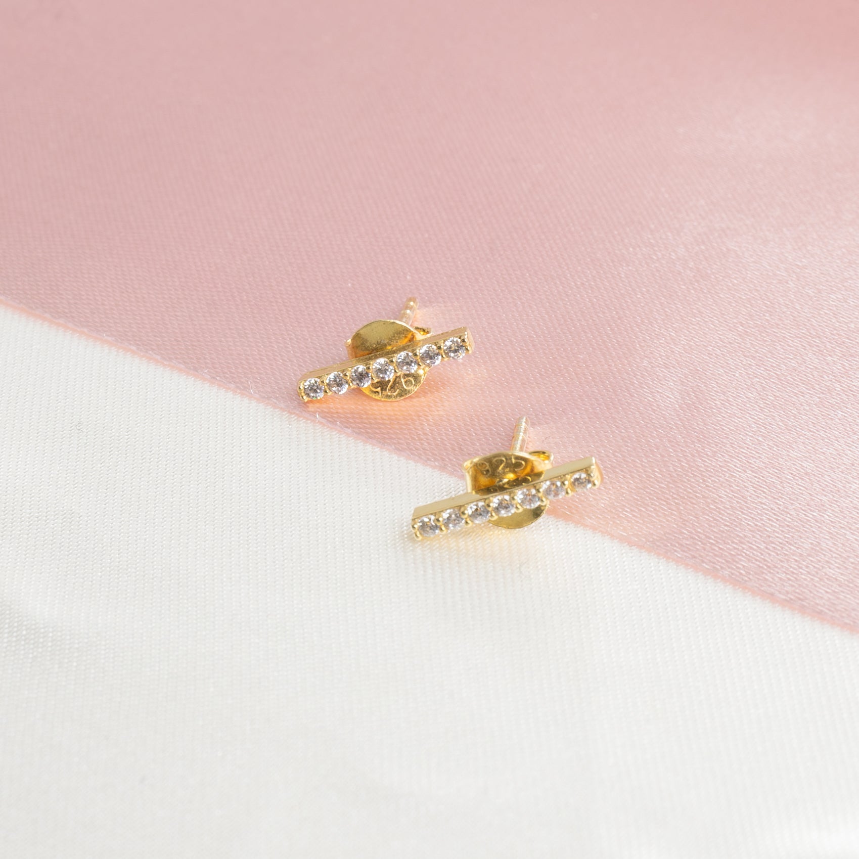 Baguette in white zircons at the lobe